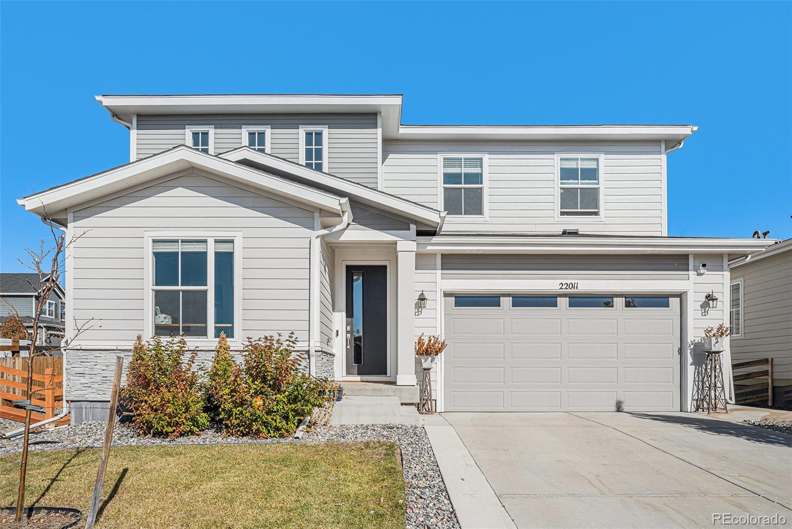22011 East Stanford Circle Aurora, CO 80015 - Photo 41 of 43 a front view of a house with garden