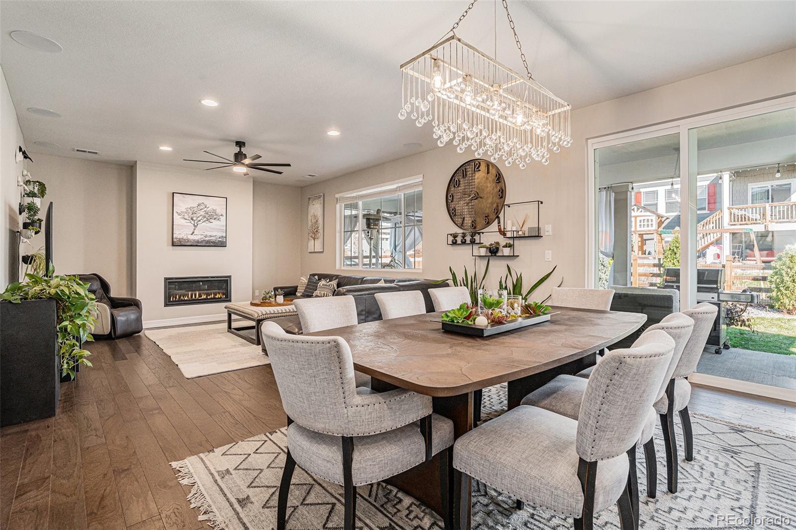 22011 East Stanford Circle Aurora, CO 80015 - Photo 8 of 43 a view of a dining room and livingroom furniture wooden floor a chandelier