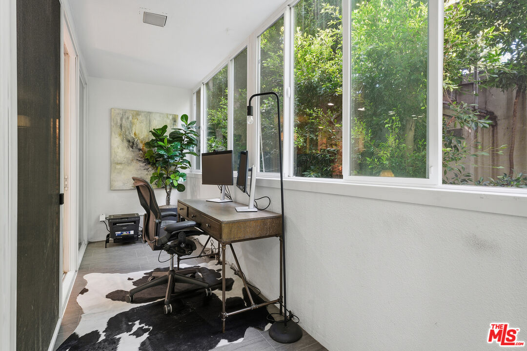 1015 North Kings Road, Unit 110 West Hollywood, CA 90069 - Photo 17 of 36 a view of a balcony with chairs and a table