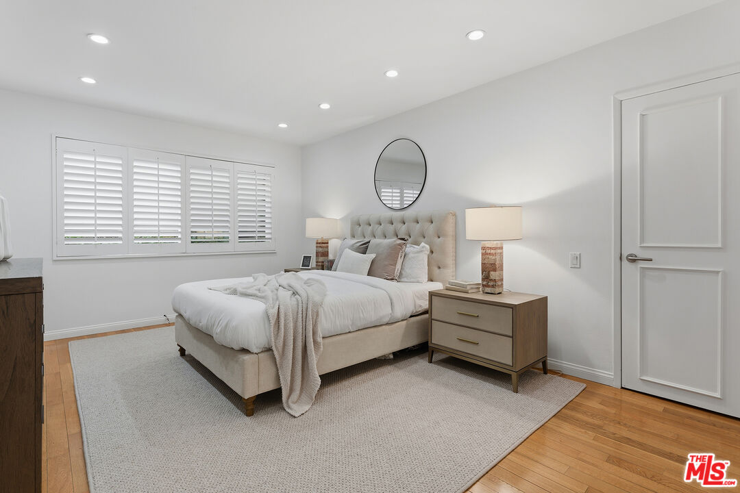 1015 North Kings Road, Unit 110 West Hollywood, CA 90069 - Photo 23 of 36 a bedroom with a bed and a window