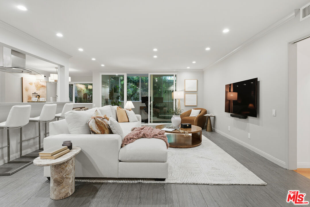 1015 North Kings Road, Unit 110 West Hollywood, CA 90069 - Photo 3 of 36 a living room with furniture and a flat screen tv