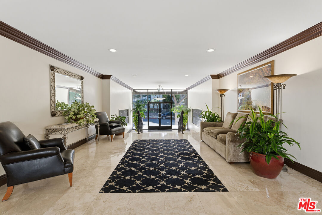 1015 North Kings Road, Unit 110 West Hollywood, CA 90069 - Photo 32 of 36 a living room with furniture and a potted plant