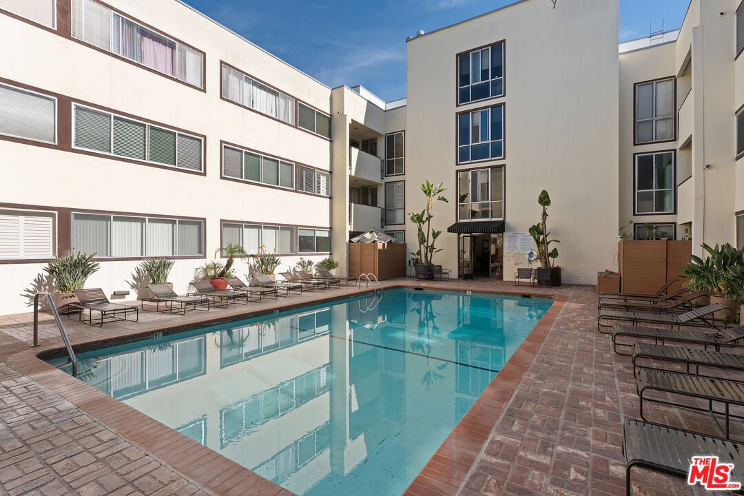 1015 North Kings Road, Unit 110 West Hollywood, CA 90069 - Photo 33 of 36 a view of a swimming pool with outdoor seating