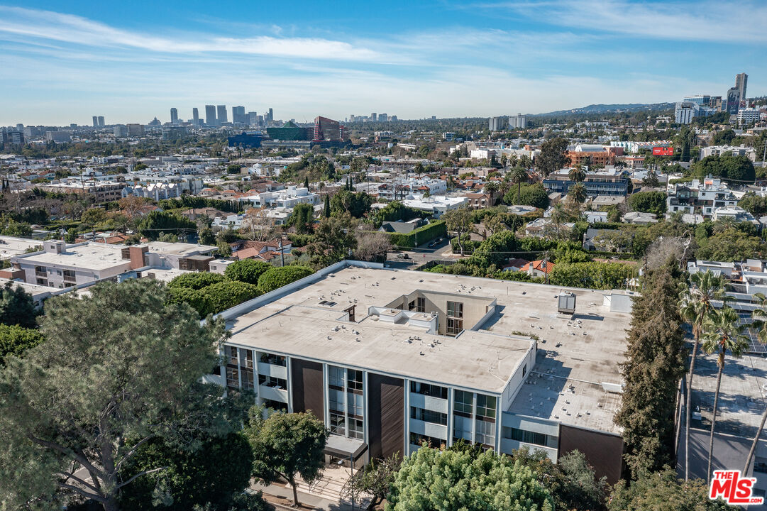 1015 North Kings Road, Unit 110 West Hollywood, CA 90069 - Photo 35 of 36 an aerial view of a house with a yard garage and lake view in back