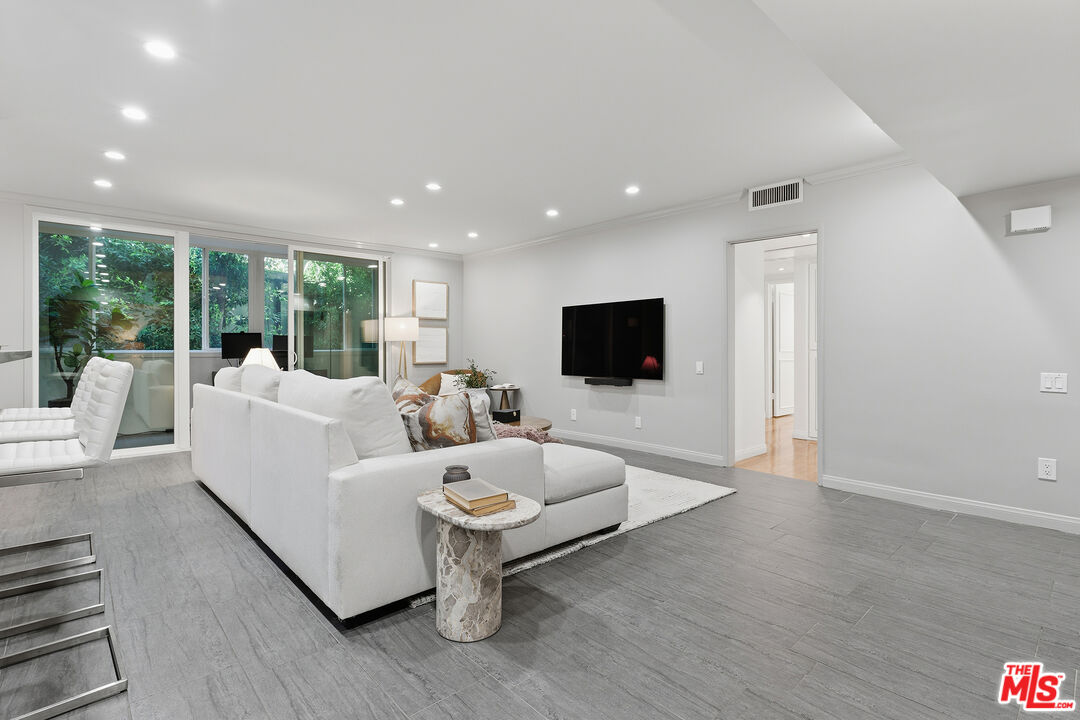1015 North Kings Road, Unit 110 West Hollywood, CA 90069 - Photo 4 of 36 a living room with furniture and a flat screen tv