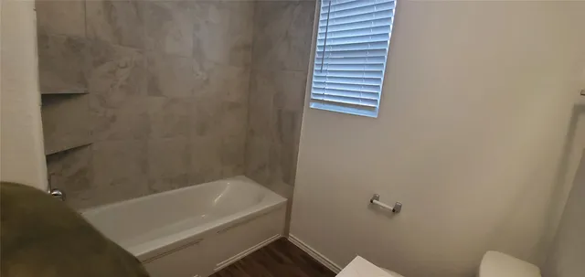 a bathroom with a tub and a shower