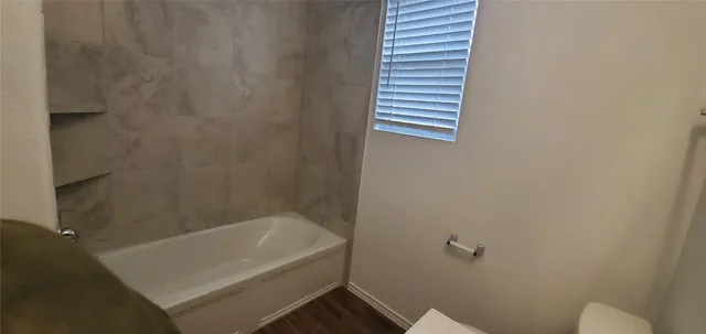 a bathroom with a tub and a shower