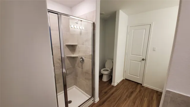 a bathroom with a glass shower door