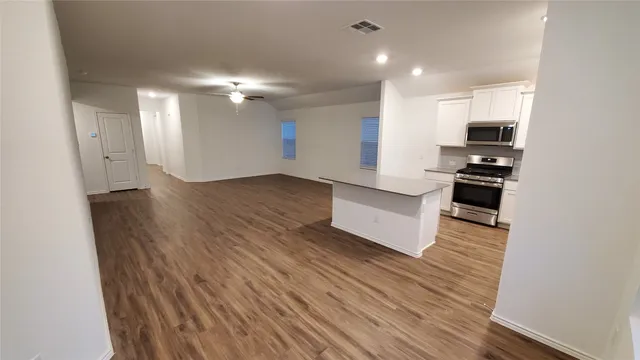 a view of kitchen with sink and refrigerator