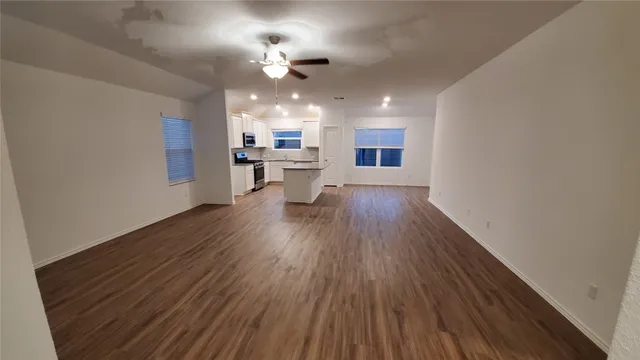 a view of a kitchen with sink and wooden floor