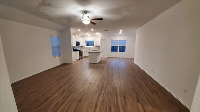 a view of a kitchen with sink and wooden floor