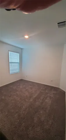 an empty room with a empty space and windows