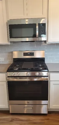 a stove top oven sitting inside of a kitchen