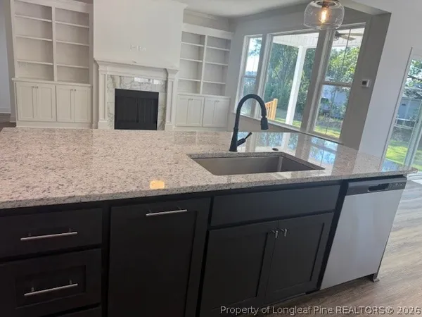 a kitchen with a sink a stove and cabinets