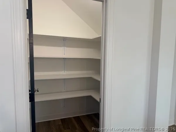 a view of walk in closet with empty racks