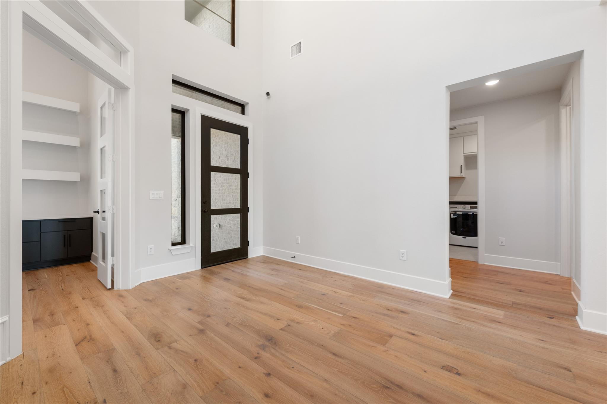 6216 Bower Well Road Austin, TX 78738 - Photo 4 of 31 an empty room with wooden floor and windows