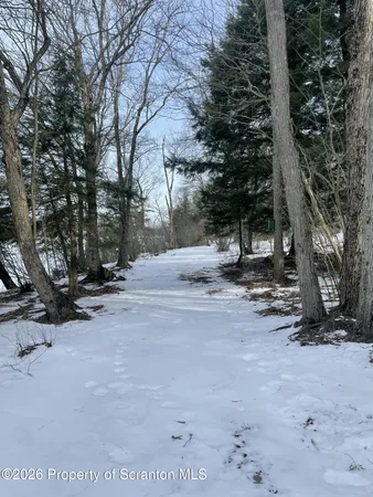 a view of a house with a snow in the yard