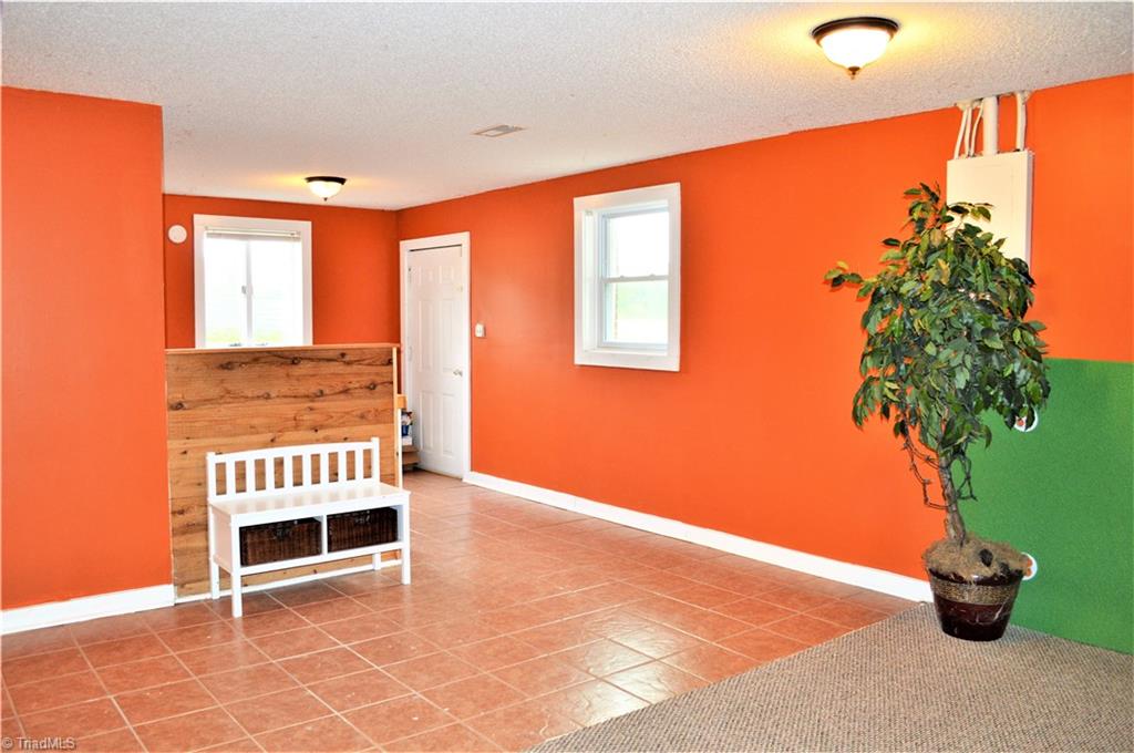 170 Baker Crossroad Road Madison, NC 27025 - Photo 22 of 30 Basement: Laundry Area, Door to Back Yard
