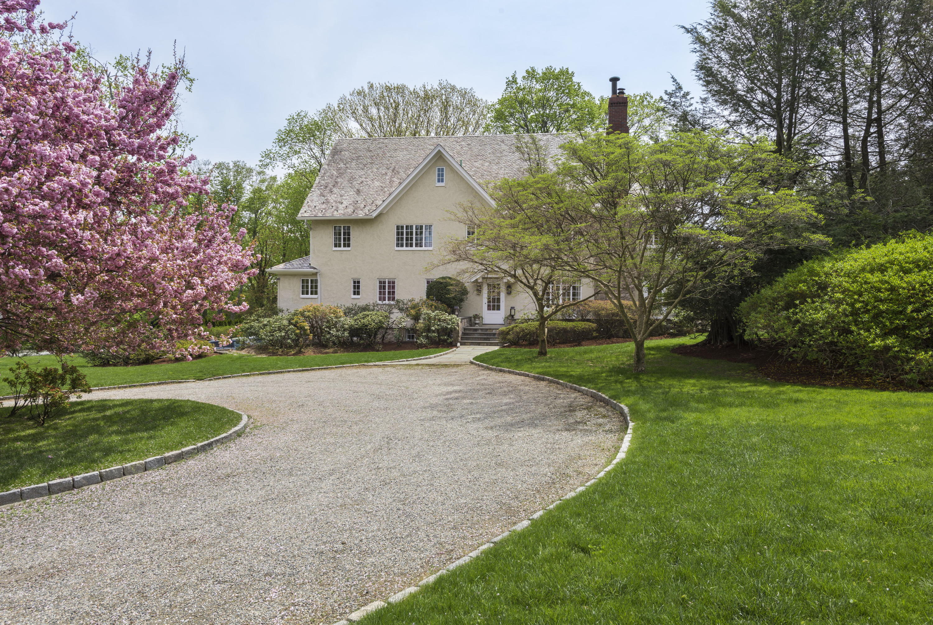 50 Upland Drive Greenwich, CT 06831 - Photo 1 of 34 a front view of a house with a yard