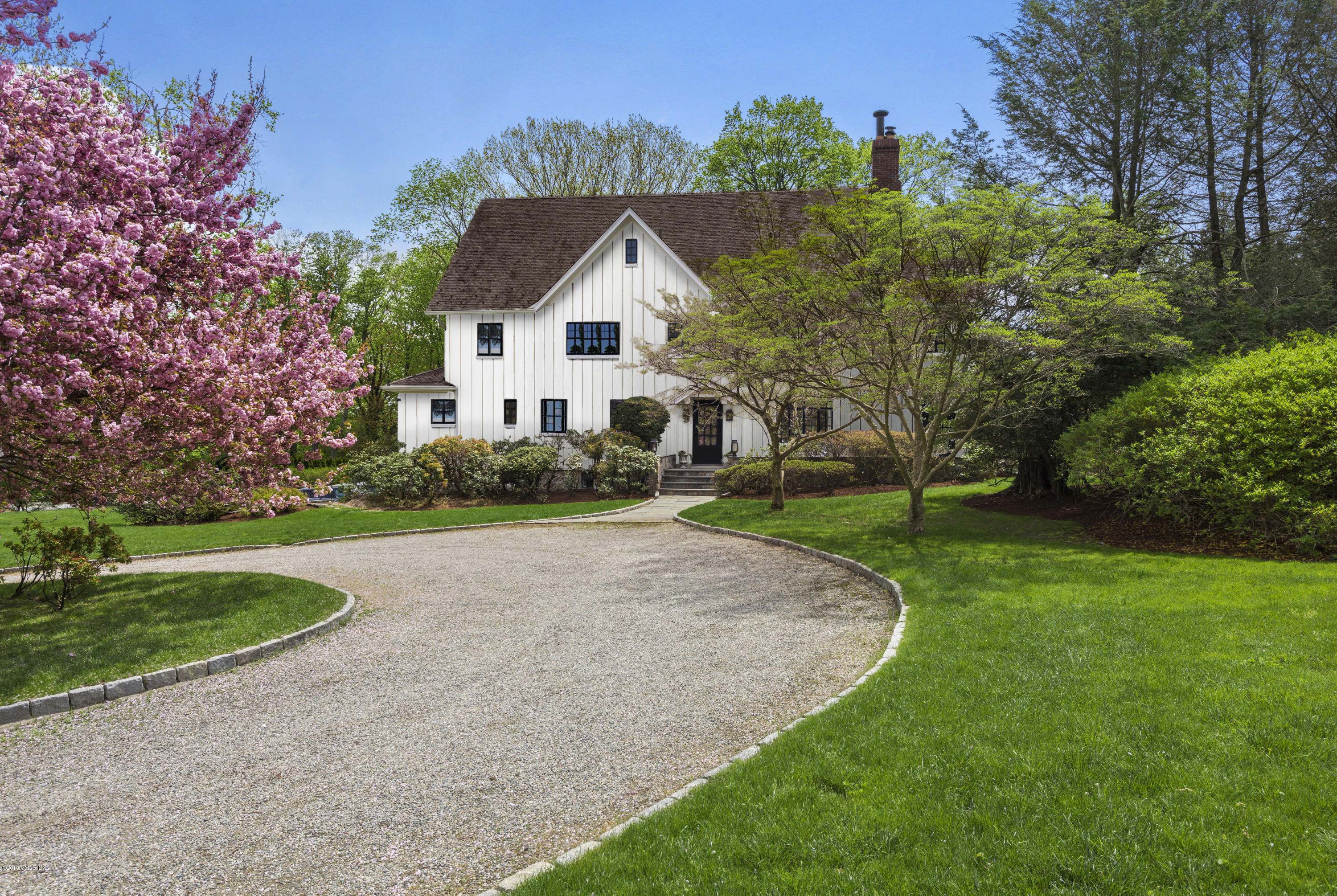 50 Upland Drive Greenwich, CT 06831 - Photo 2 of 34 a view of a white house with a big yard plants and large trees