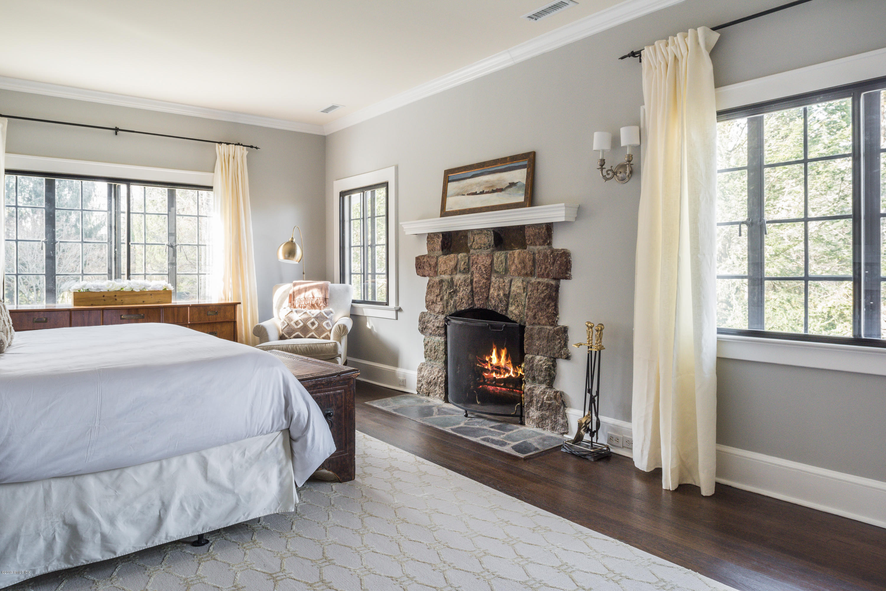 50 Upland Drive Greenwich, CT 06831 - Photo 23 of 34 a bedroom with a bed a fireplace and a window