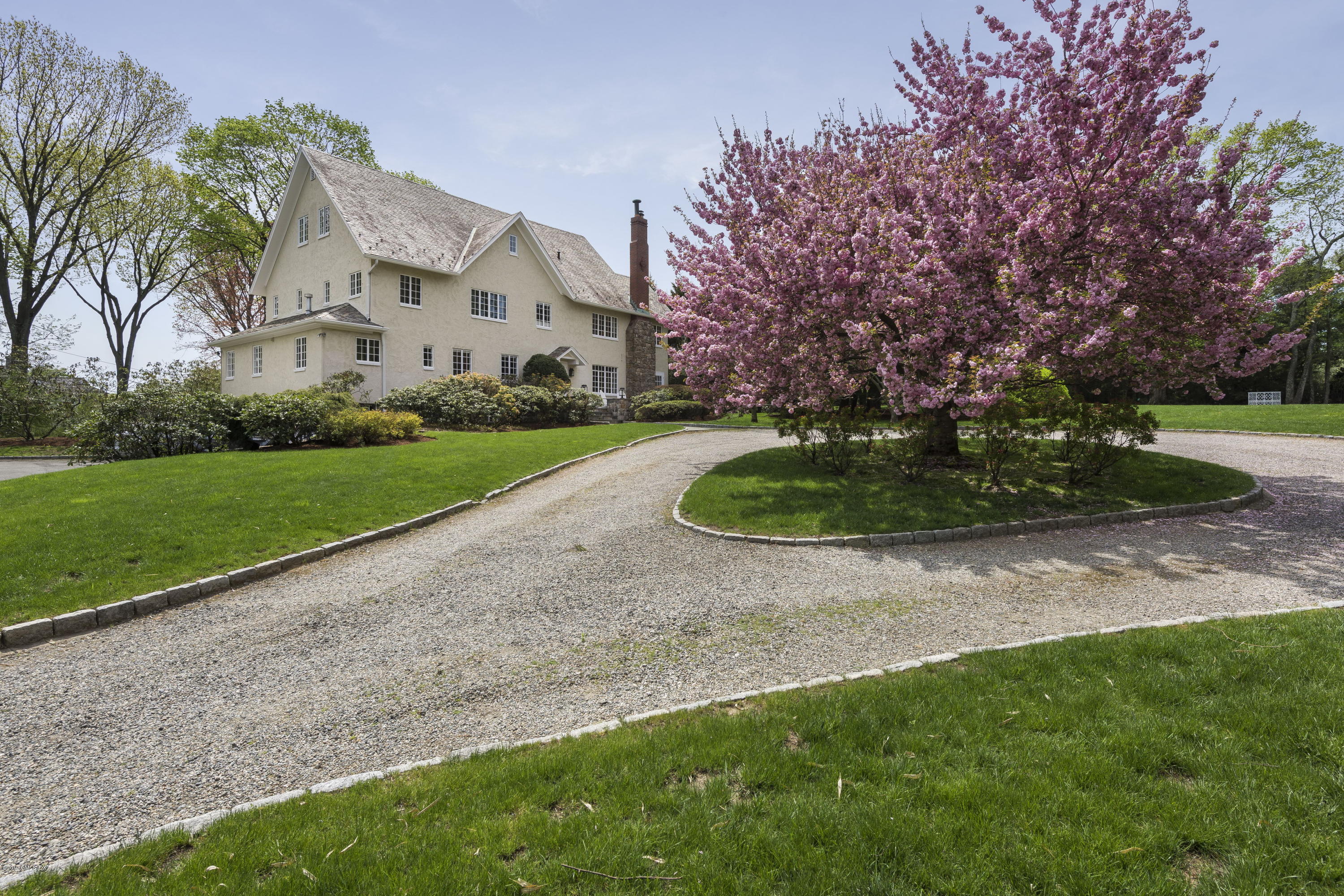 50 Upland Drive Greenwich, CT 06831 - Photo 3 of 34 a front view of a house with a yard