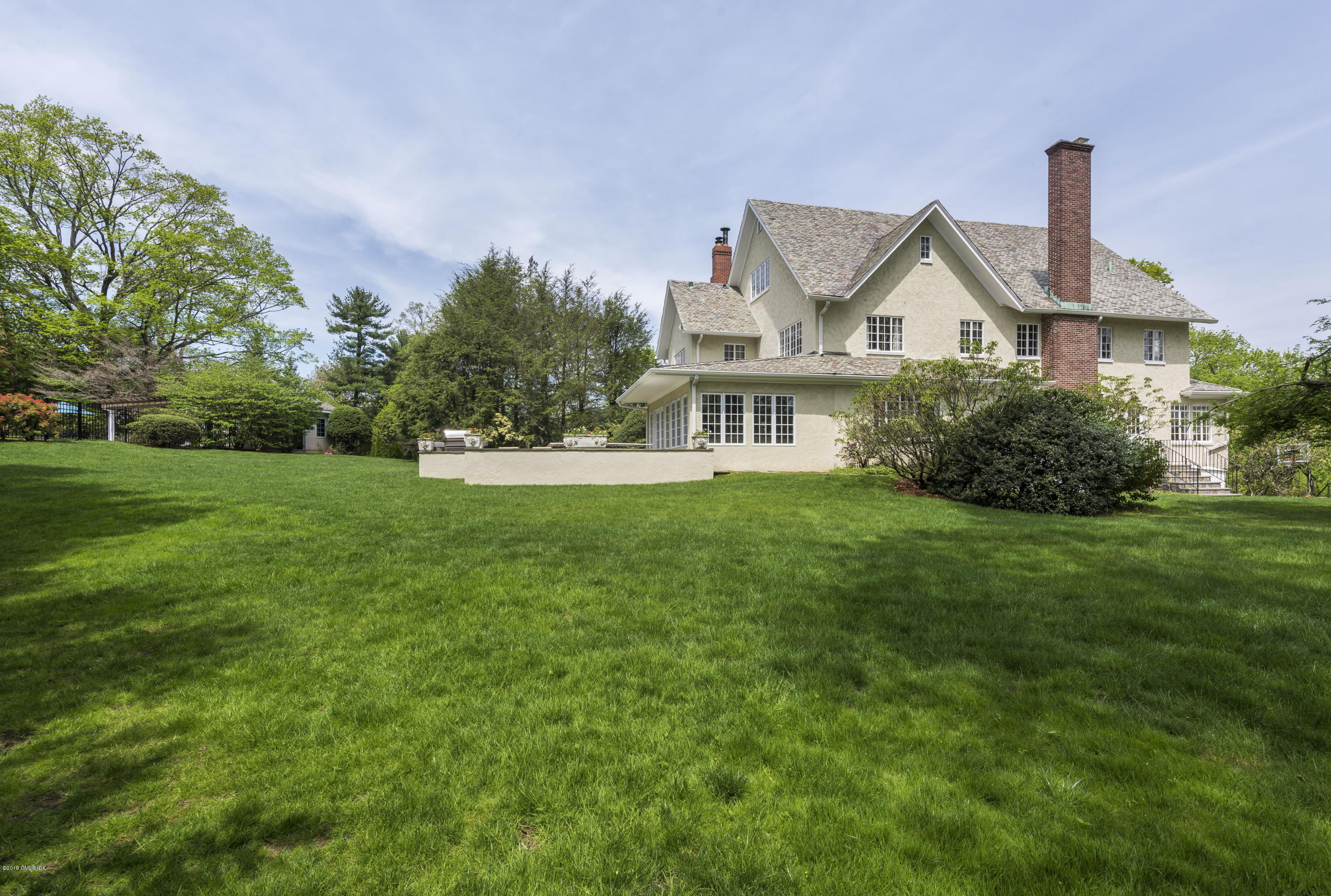 50 Upland Drive Greenwich, CT 06831 - Photo 31 of 34 a front view of a house with garden