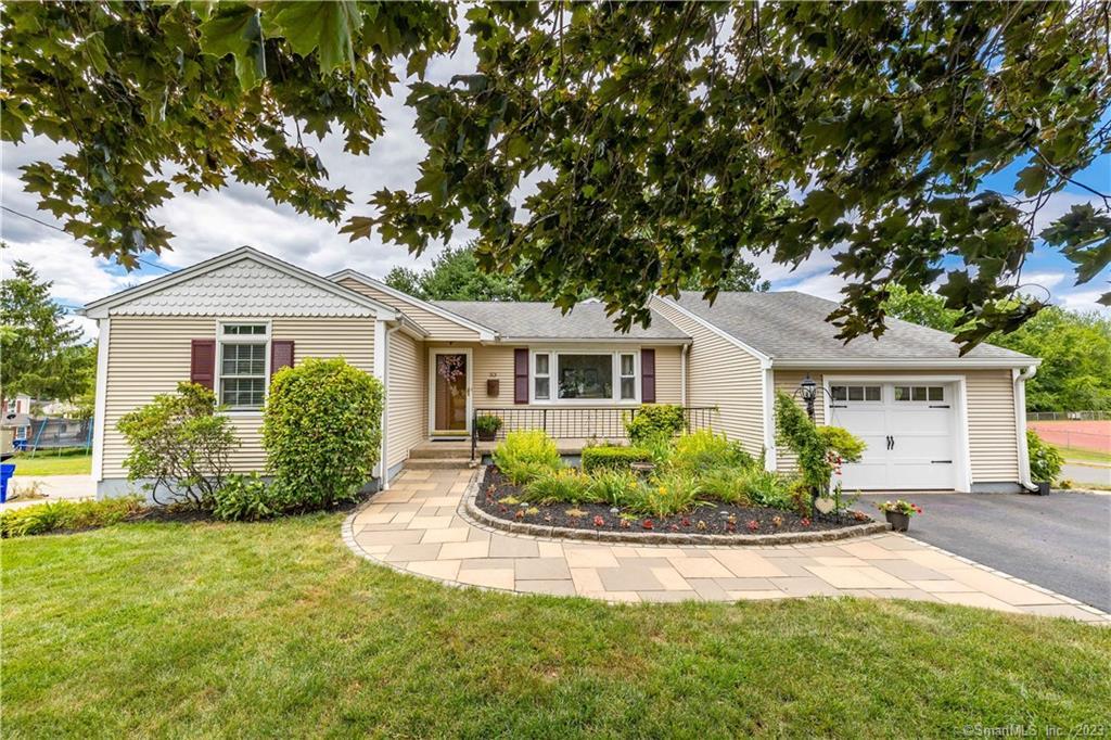 a front view of a house with garden