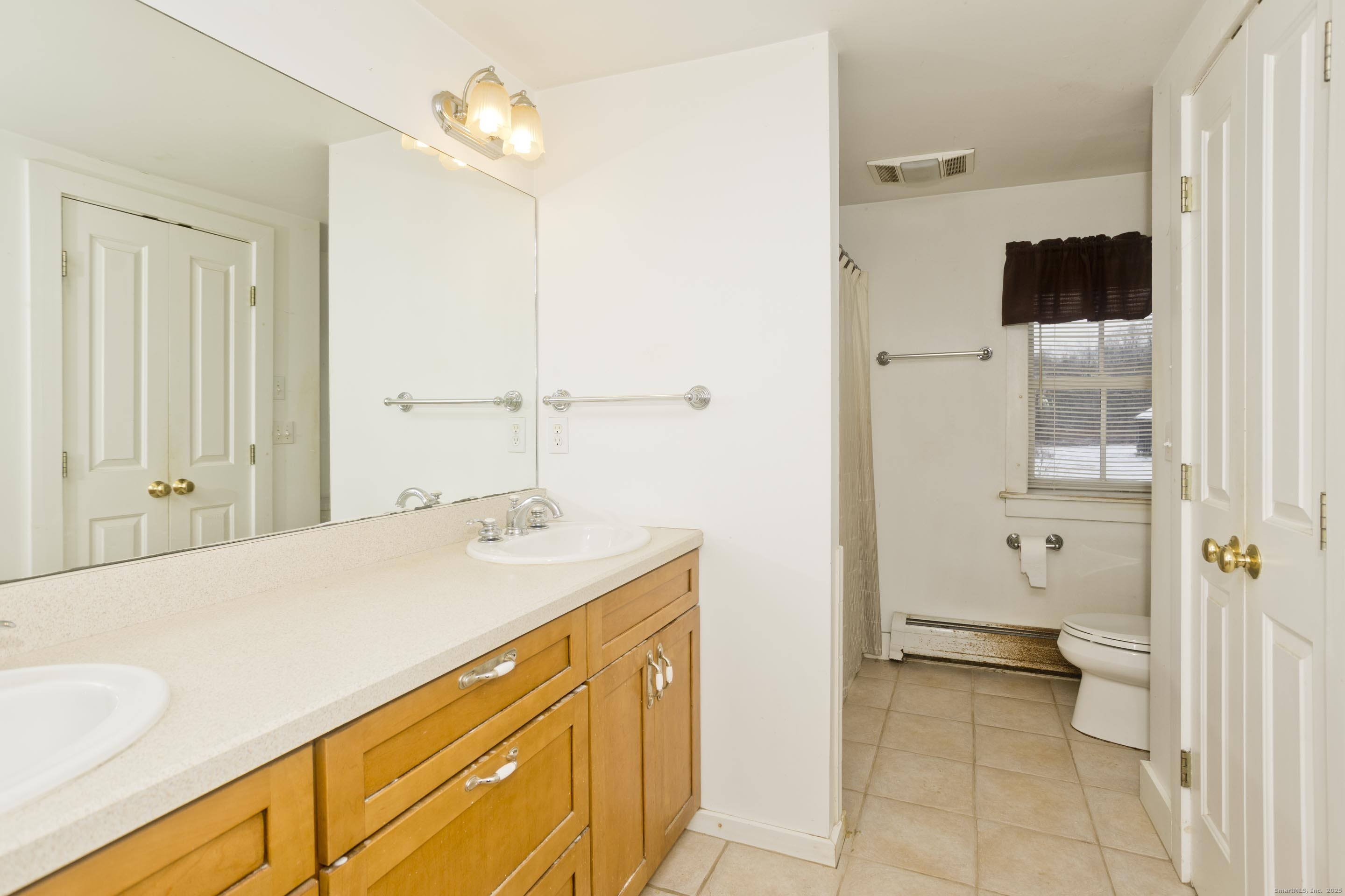 1095 South Grand Street Suffield, CT 06093 - Photo 13 of 31 a bathroom with a sink and a mirror