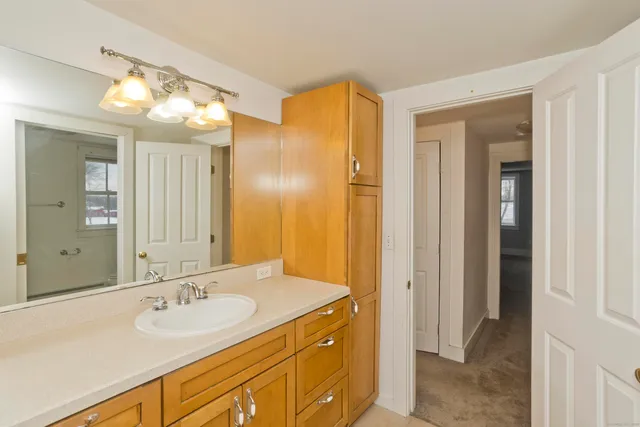 an empty room with closet and windows