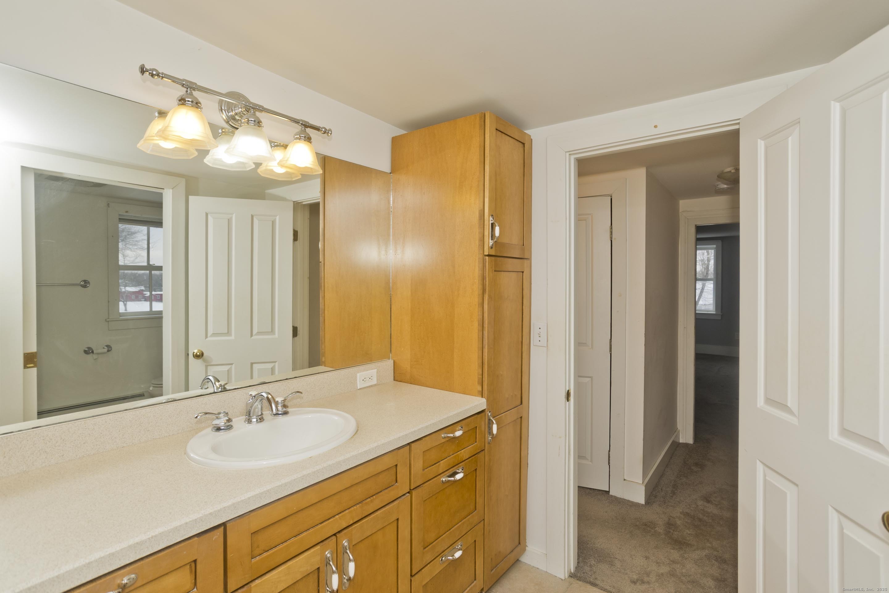 1095 South Grand Street Suffield, CT 06093 - Photo 15 of 31 a bathroom with a sink and a mirror
