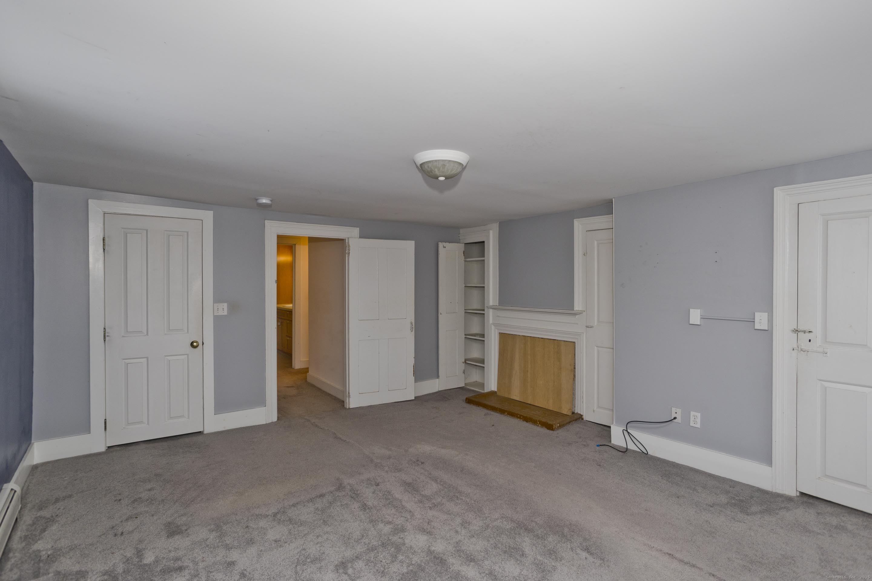 1095 South Grand Street Suffield, CT 06093 - Photo 16 of 31 an empty room with closet and windows