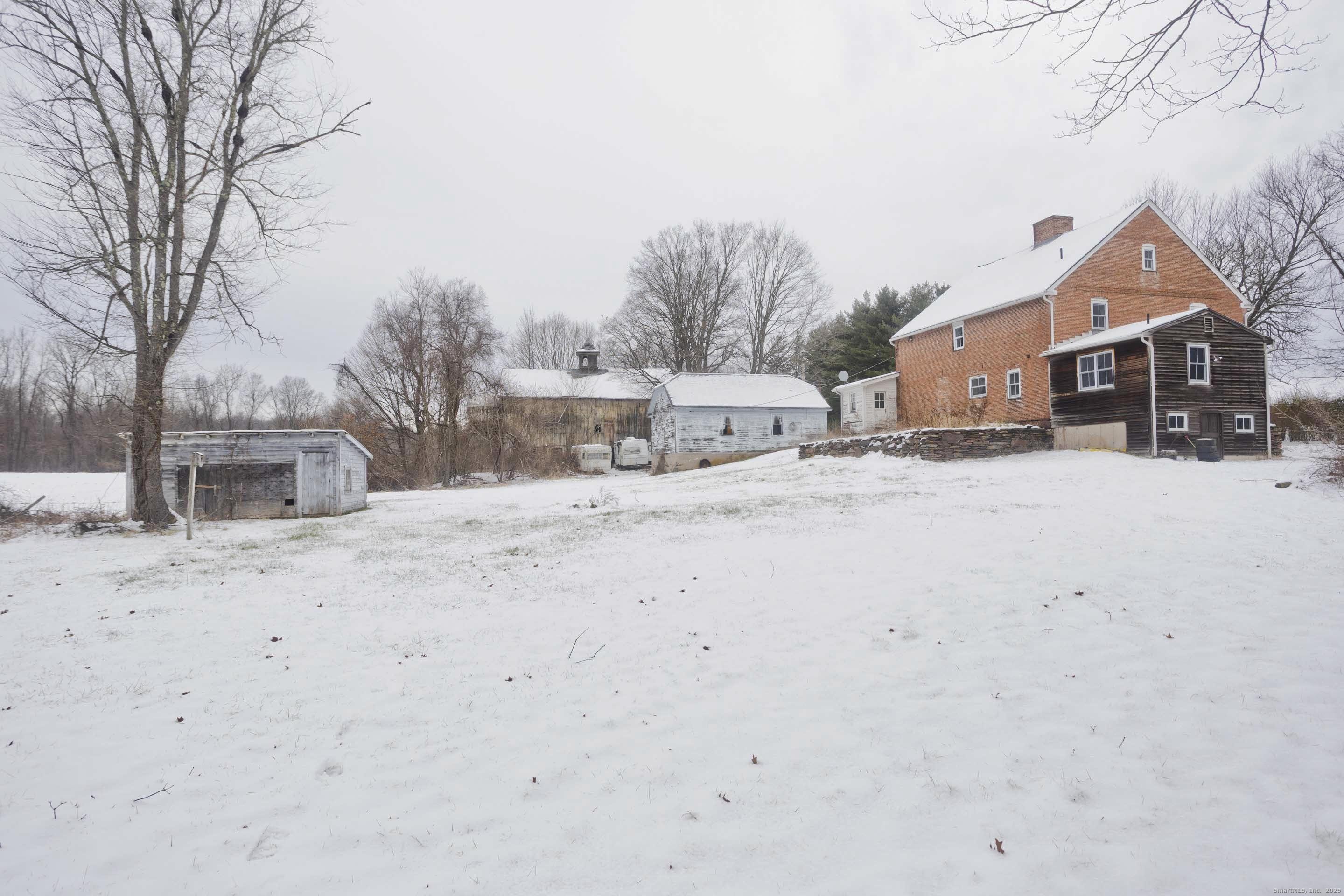 1095 South Grand Street Suffield, CT 06093 - Photo 22 of 31 a view of a house with a snow in the yard