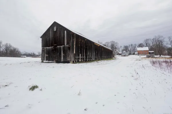 a view of yard covered with snow in the background