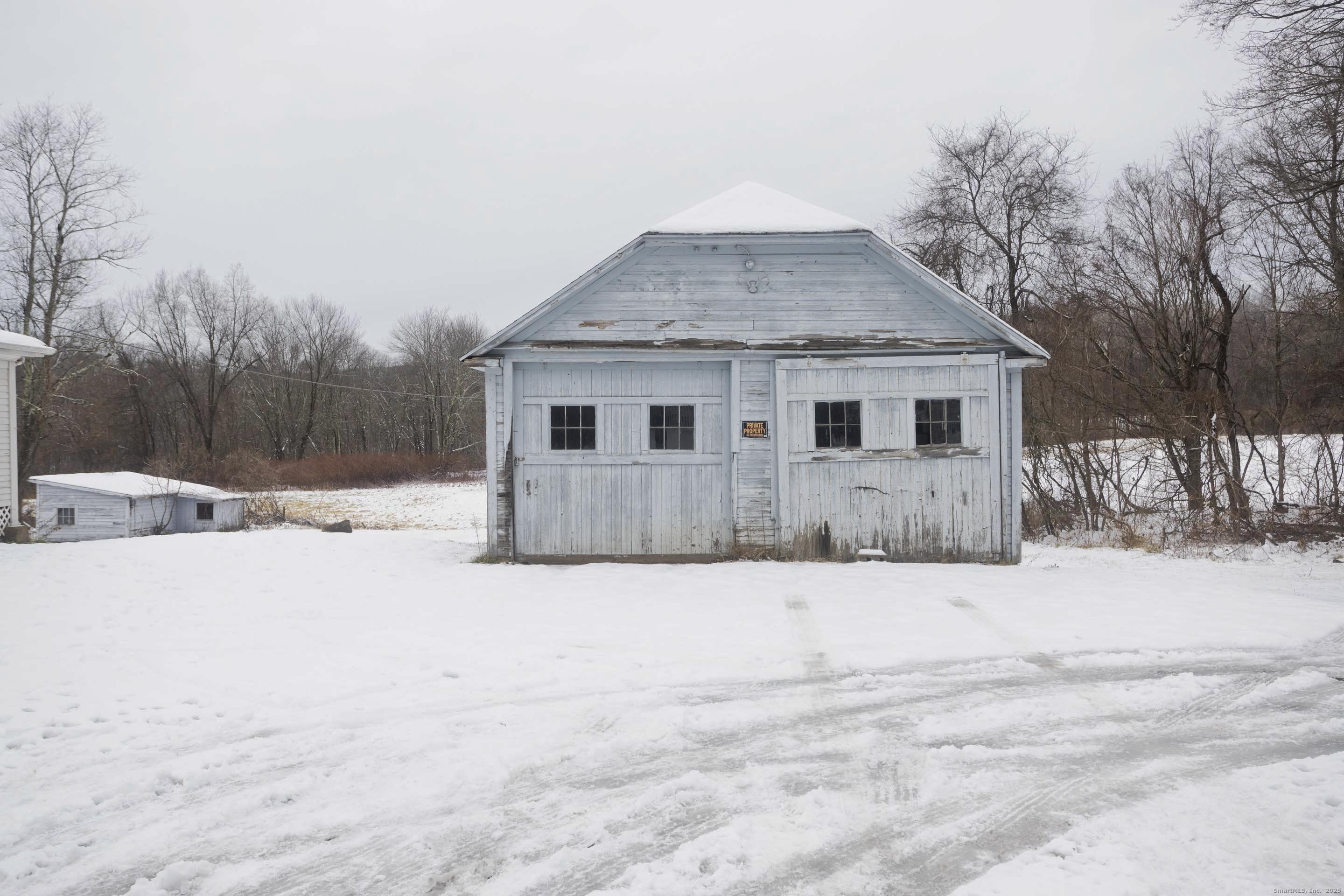 1095 South Grand Street Suffield, CT 06093 - Photo 5 of 31 a front view of a house with a yard covered in snow