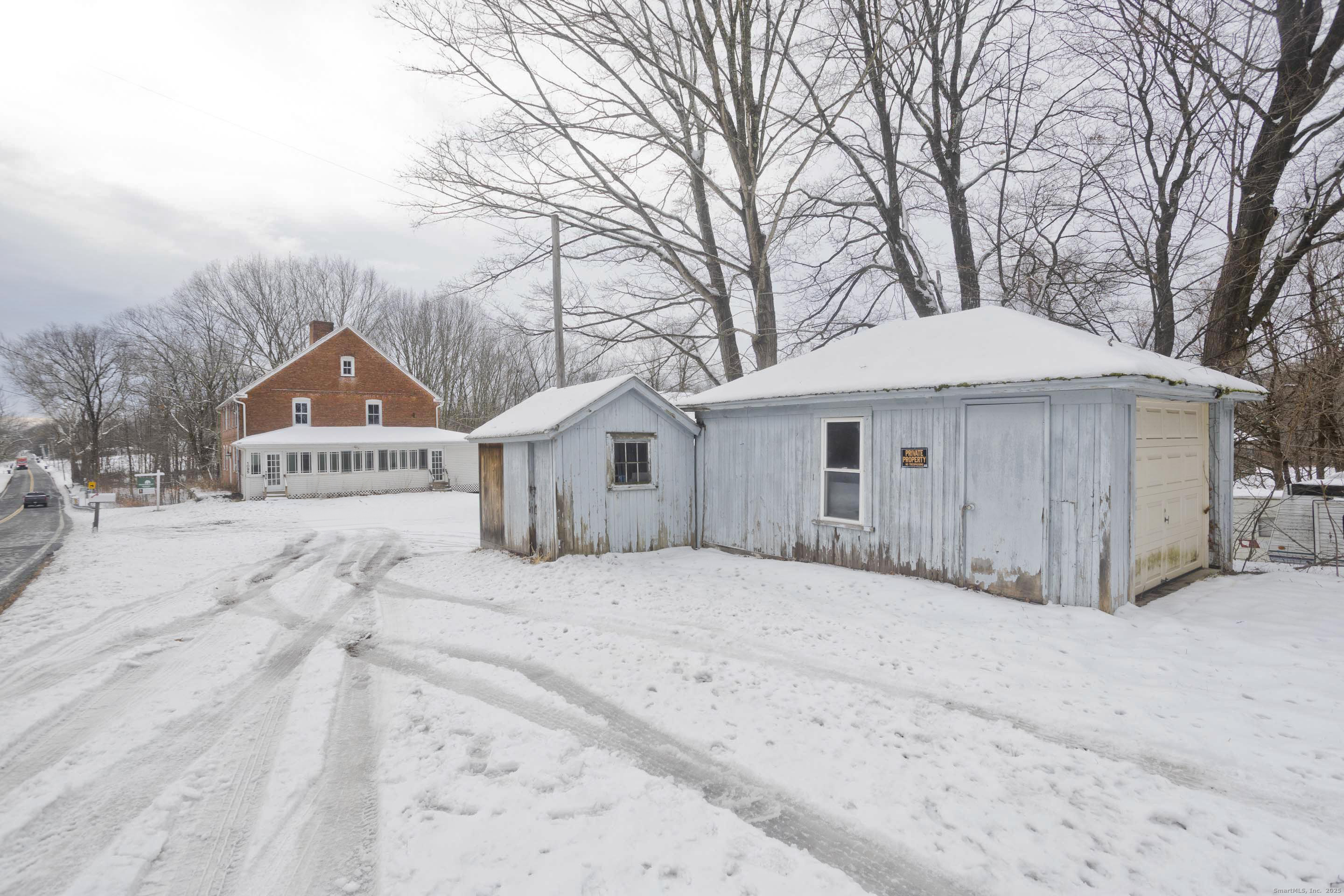 1095 South Grand Street Suffield, CT 06093 - Photo 6 of 31 a front view of a house with a yard and garage