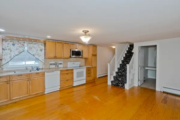 a kitchen with stainless steel appliances granite countertop a refrigerator and a sink