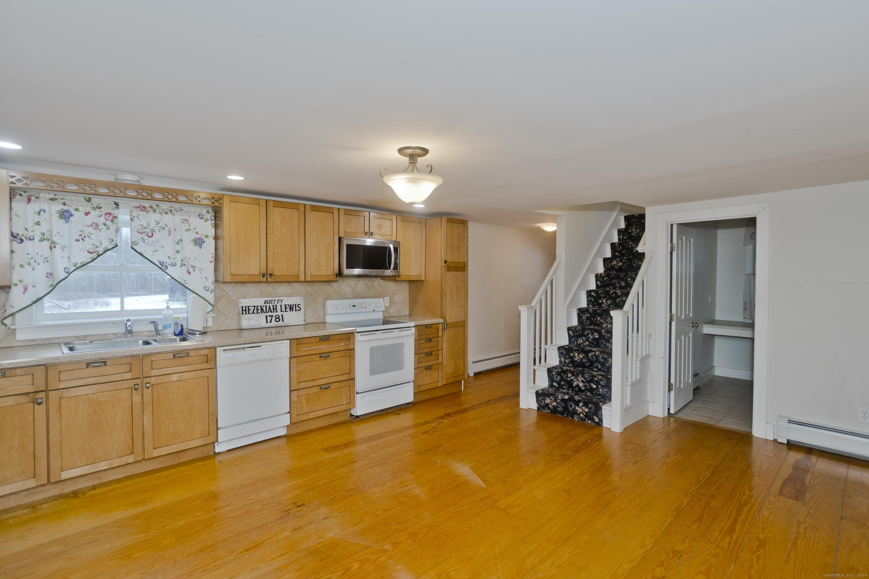 1095 South Grand Street Suffield, CT 06093 - Photo 7 of 31 a kitchen with granite countertop a refrigerator and stove top oven