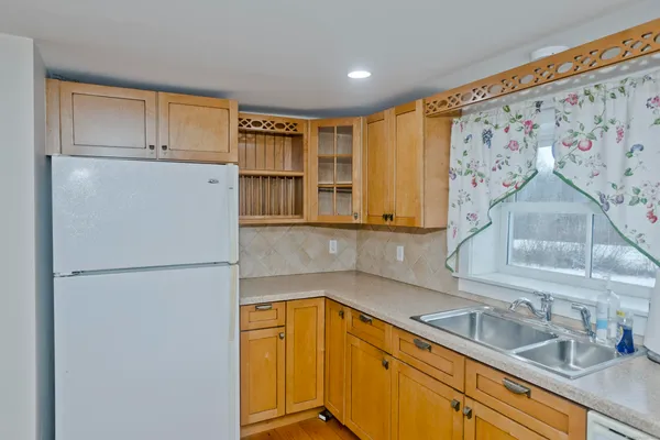 a large kitchen with cabinets and stainless steel appliances