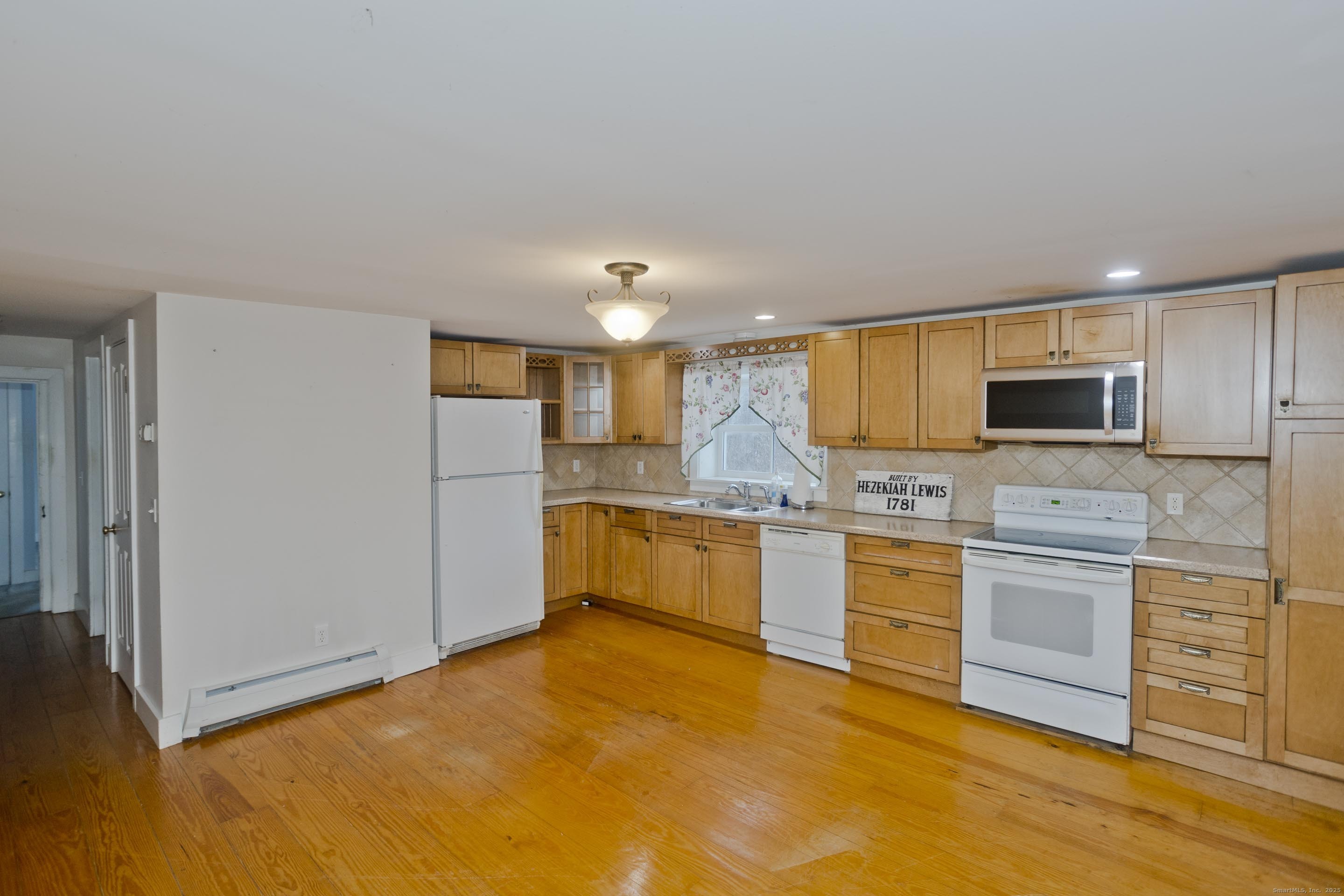 1095 South Grand Street Suffield, CT 06093 - Photo 9 of 31 a large kitchen with cabinets and stainless steel appliances