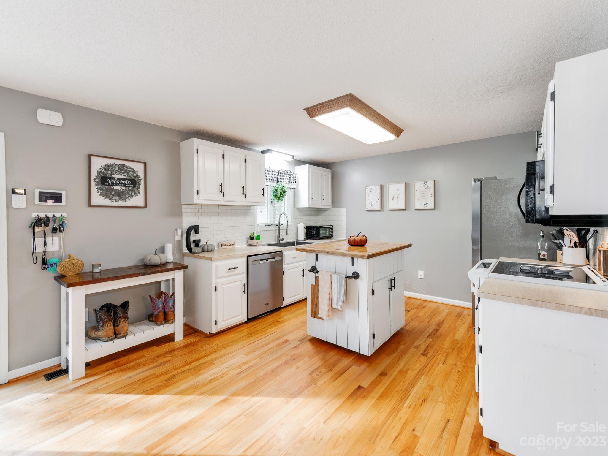 33702 Western Road Albemarle, NC 28001 - Photo 13 of 42 a kitchen with a sink cabinets and wooden floor