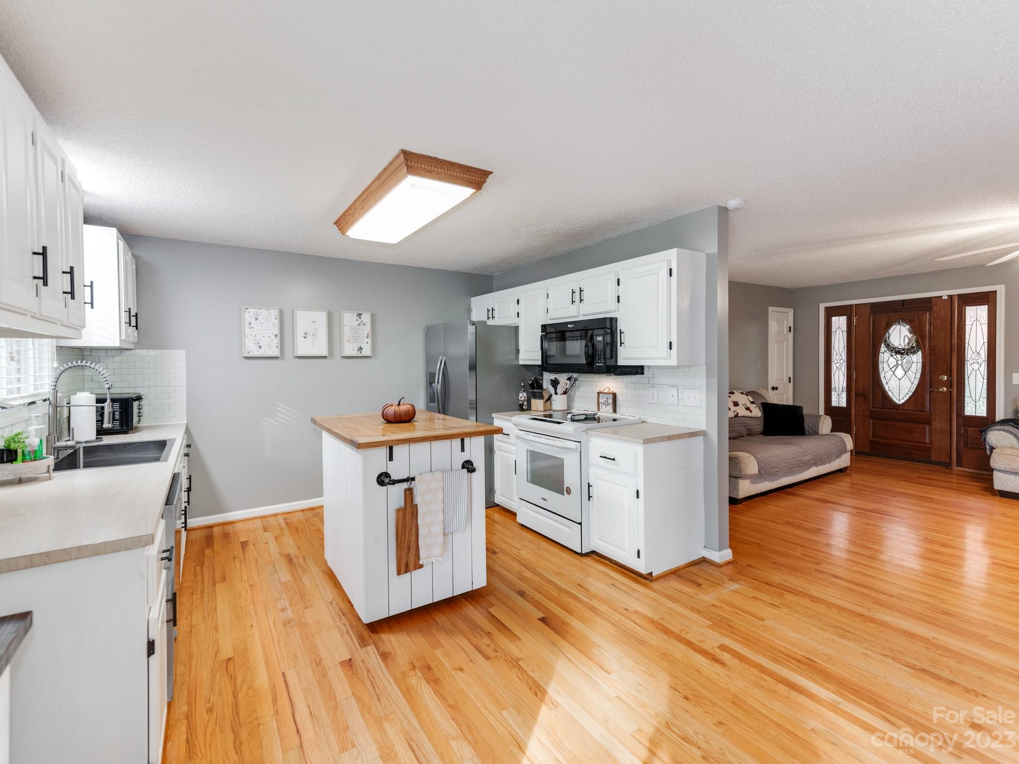 33702 Western Road Albemarle, NC 28001 - Photo 14 of 42 a open kitchen with white cabinets and stainless steel appliances