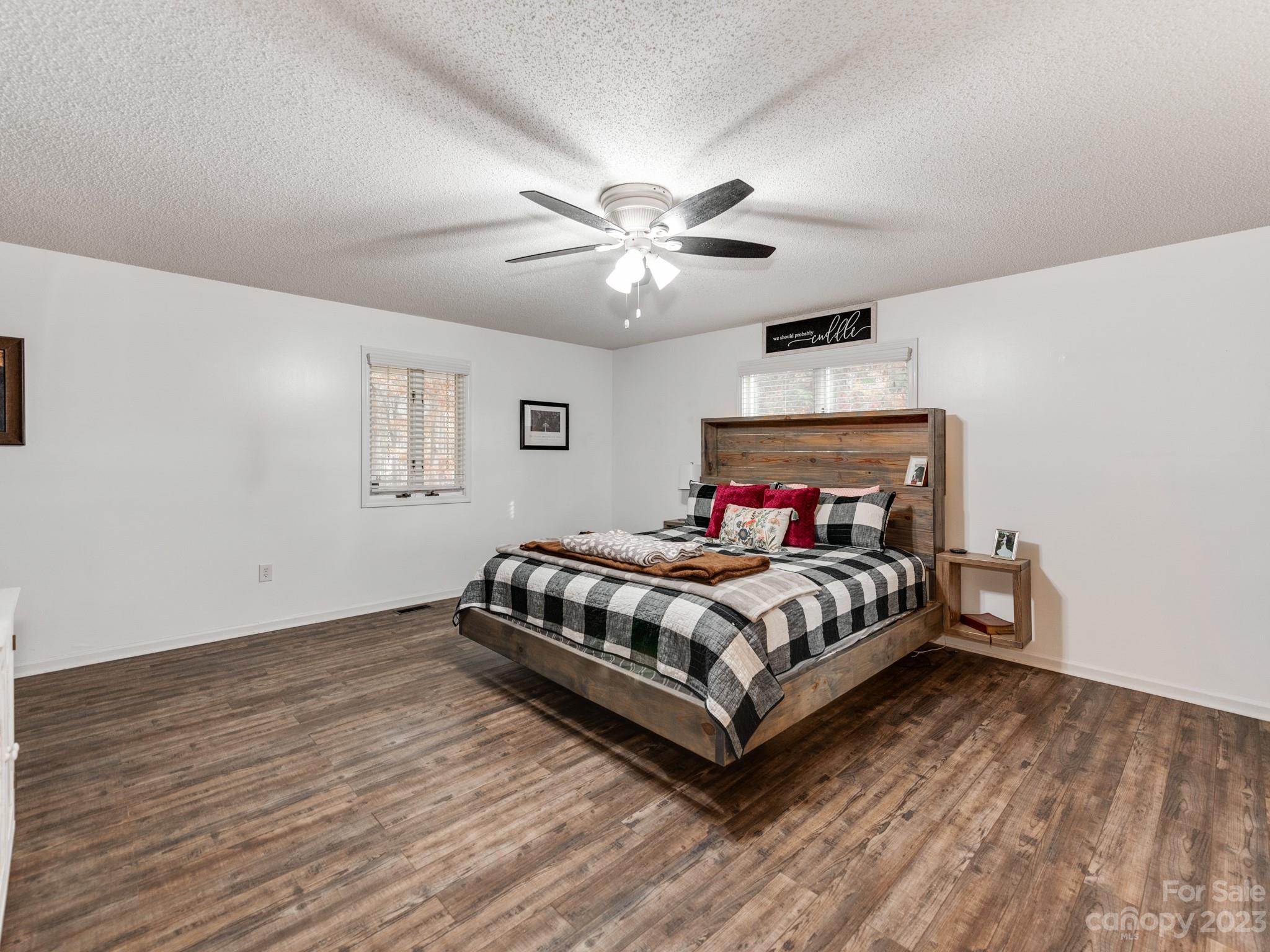 33702 Western Road Albemarle, NC 28001 - Photo 17 of 42 a bedroom with a bed and a chandelier