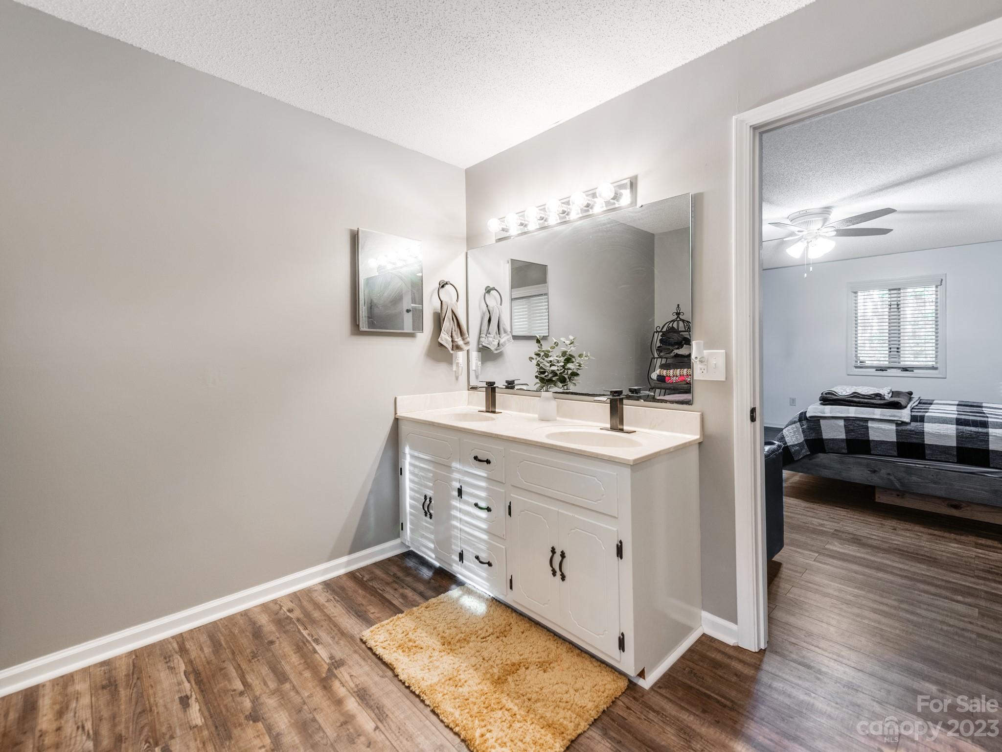 33702 Western Road Albemarle, NC 28001 - Photo 19 of 42 a spacious bathroom with a double vanity sink and a mirror