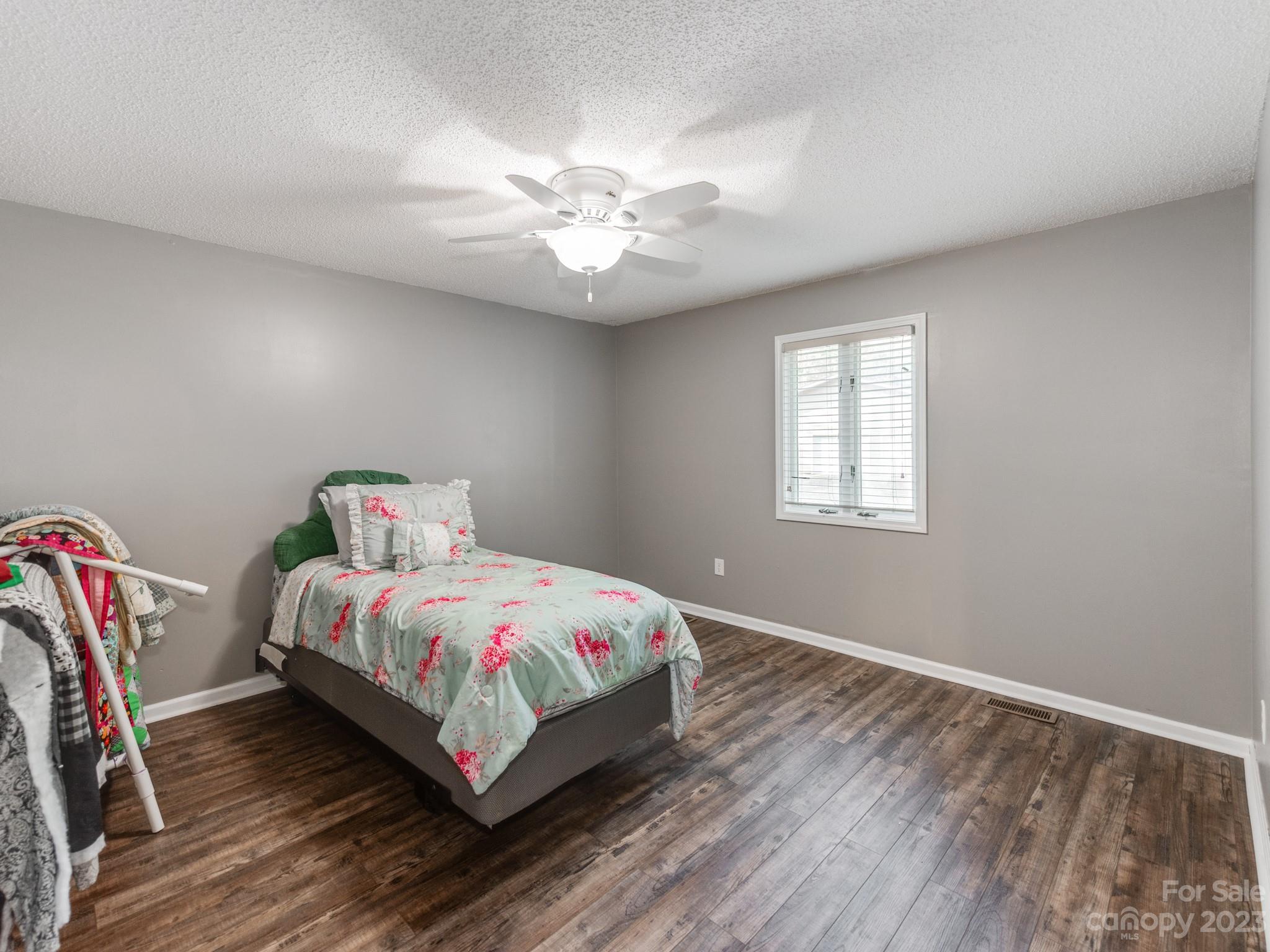 33702 Western Road Albemarle, NC 28001 - Photo 22 of 42 a bedroom with a bed and chandelier