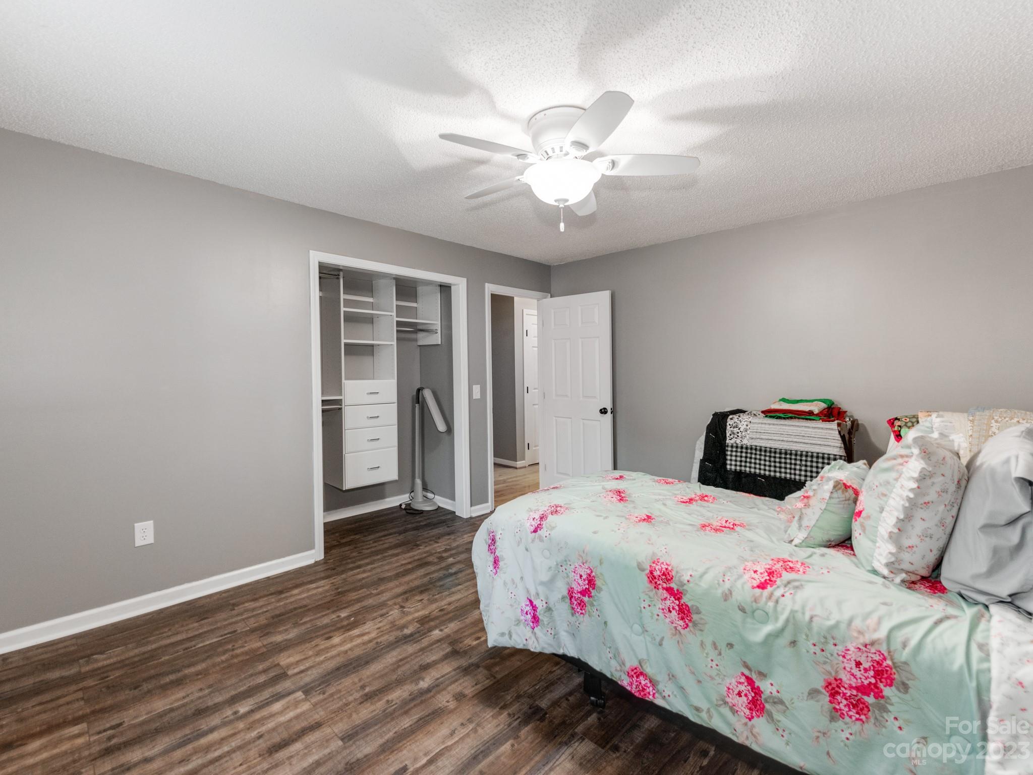 33702 Western Road Albemarle, NC 28001 - Photo 23 of 42 a bed room with a bed and a chandelier