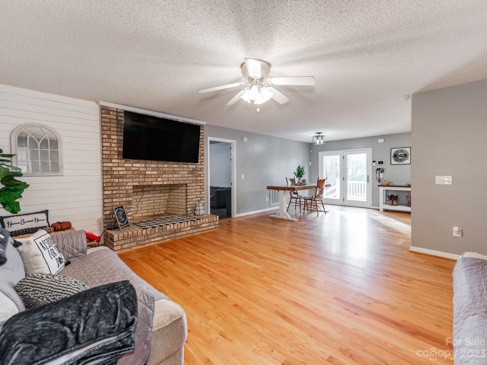 33702 Western Road Albemarle, NC 28001 - Photo 9 of 42 a living room with fireplace furniture and a flat screen tv