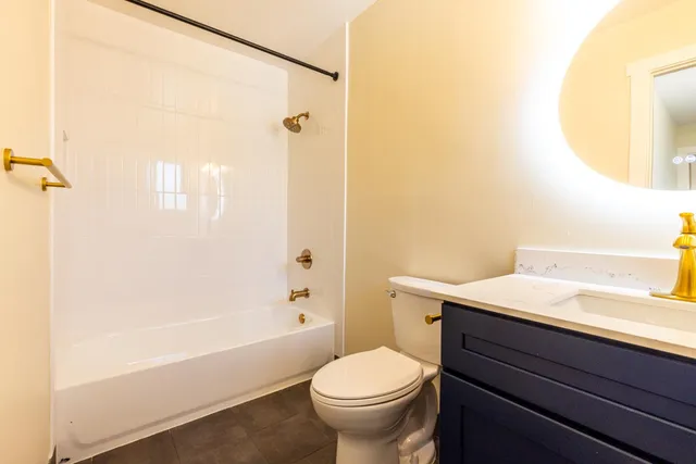 a bathroom with a toilet a sink and mirror