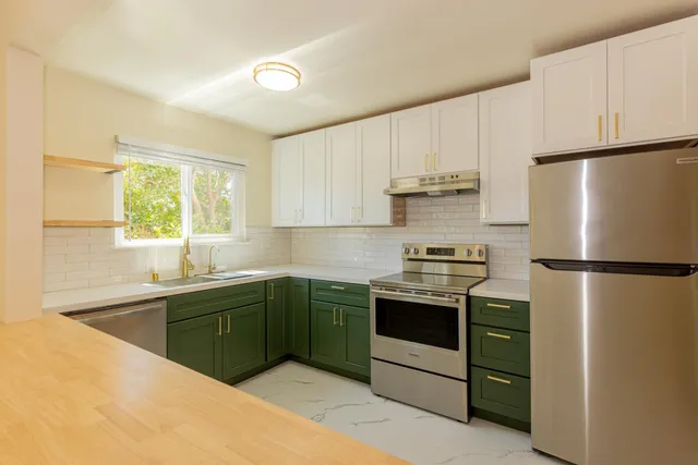 a kitchen with kitchen island a counter top space and a refrigerator