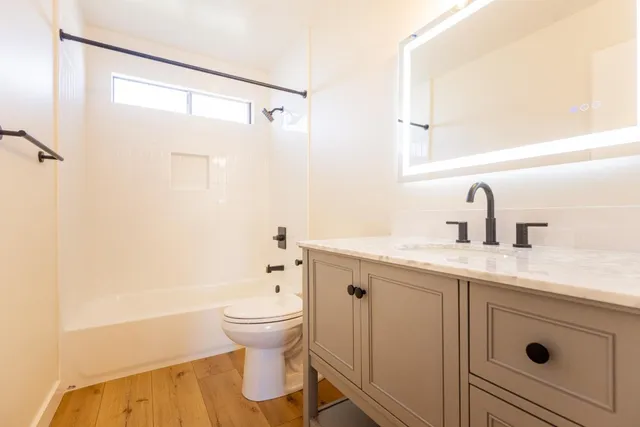 a kitchen with cabinets appliances a sink and a window